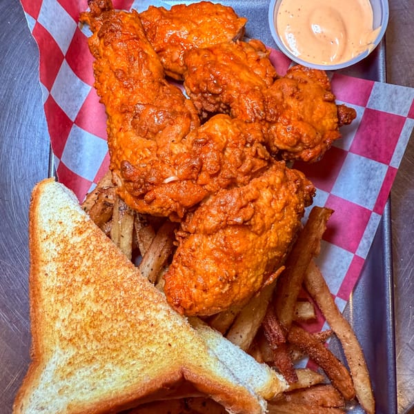 SideChick HTX fried chicken tenders, fries, Texas toast, and dipping sauce on a tray.